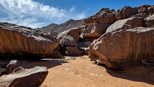 Massive rocks in a sunny desert landscape under a clear blue sky, rocky landscape in the Sahara in
