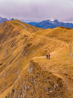 Couple on a path with a view of the autumnal mountain landscape, Alpen Tower, Switzerland
