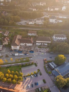 Aerial view of a residential area with streets, trees and several buildings, Badischer Hof, Calw,