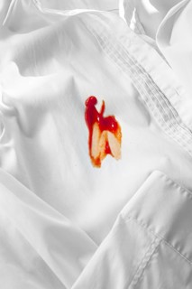 White shirt stained with ketchup, no people, close-up, selective focus