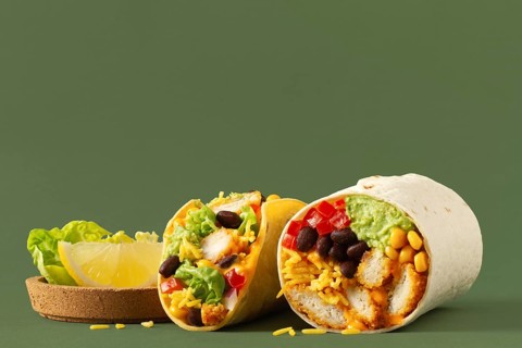 Mouthwatering taco and burrito cut in half, revealing a colorful mix of chicken, black beans, corn,