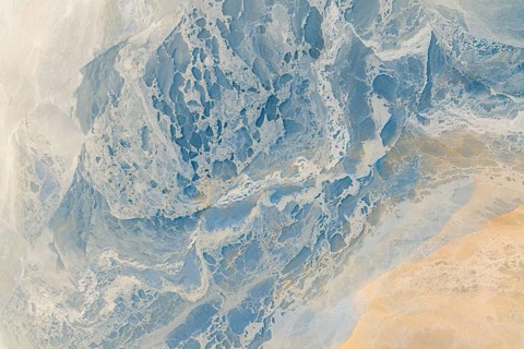 A breathtaking aerial photograph featuring a multicolour abstract landscape. This image captures an