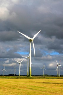 Wind turbines in front of a stormy sky in a rape field, East Frisia, Lower Saxony, Federal Republic
