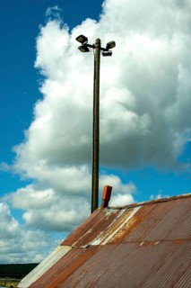 Lamppost and rusty tin roof. France