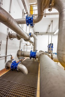 Complex pipe system with robust metal grid floor, ENCW Netze Calw waterworks, Calw, Black Forest,