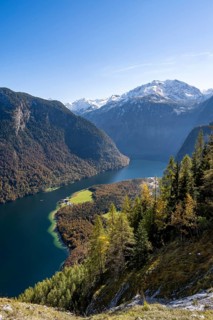 View of the Königssee from the Rinnkendlsteig mountain hiking trail, autumnal forest and