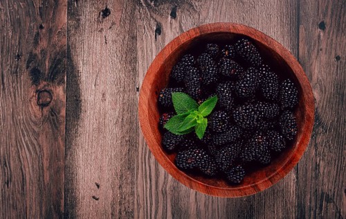 Blackberries, in a wooden bowl, top view, no people