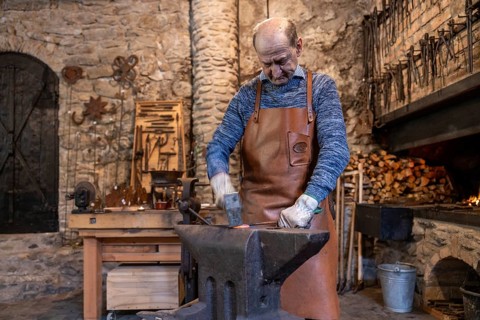 An elderly blacksmith in Salzburg, Austria, continues centuries-old metalworking traditions in his