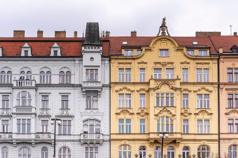 A detailed view of ornate historical facades in Prague, featuring intricate designs, arched
