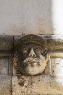 Sculpted face and carved architectural details on outside wall of The Cathedral of Saint James,