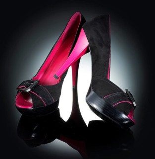 1 pair of shoes, women's shoes, in front of a black background with spot lighting, studio shot