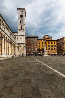 Dark rain clouds over the bell tower of the church of San Michele in Foro, historic city centre,