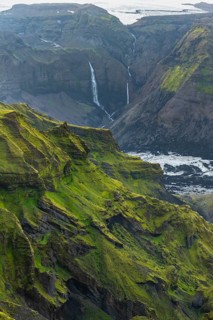Moss-covered mountains at sunset, waterfalls on a cliff at Myrdalsjökull glacier, Pakgil, Iceland