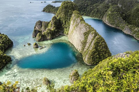 From above, a drone captures the breathtaking Raja Ampat Archipelago in Indonesia. The image shows