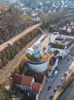 Urban landscape with crane, buildings and river, photographed from a bird's eye view, staircase