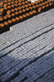 Top view of aluminium ingots and coils of flat rolled steel waiting for shipment at a terminal in