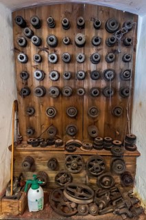 Tuchmachermuseum Bramsche, Lower Saxony, Germany, wall full of cogwheels of different sizes and