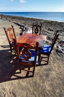 Wooden table and four chairs, fish restaurant on the beach, Playa Quemada, Yaiza, Lanzarote, Spain