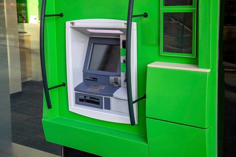 ATM banking machine in financial city business center ready for electronic money withdrawal