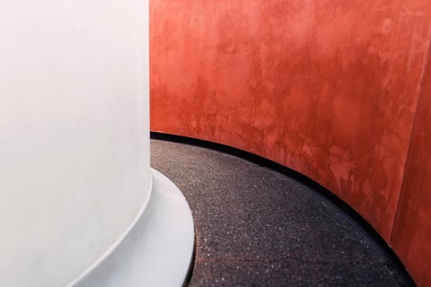 An eye-catching minimalist architectural detail featuring a smooth white column juxtaposed with a