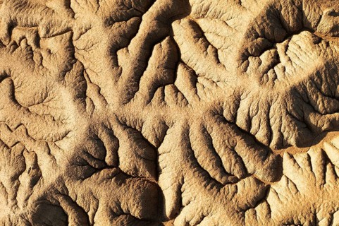 Aerial view capturing detailed patterns formed in the desert The shadows enhance the texture of the