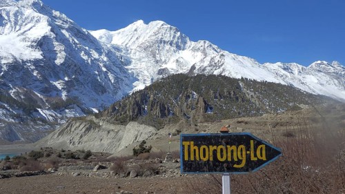 Guide to Thorong La Pass, Thorung La Pass, against snow-capped mountains and blue skies, trekking