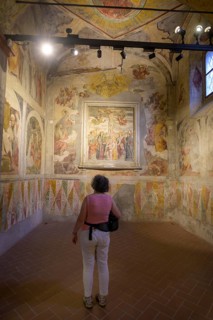 Woman looking at frescoes in the Basilica of San Salvatore, Brescia, Province of Brescia, Italy