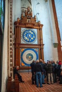 Group of tourists at the Astronomical Clock in St. Mary's Church in Lübeck, Schleswig-Holstein,
