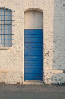 Detailed view of an old blue weathered long hall door in the evening light, Bremerhaven, Bremen,