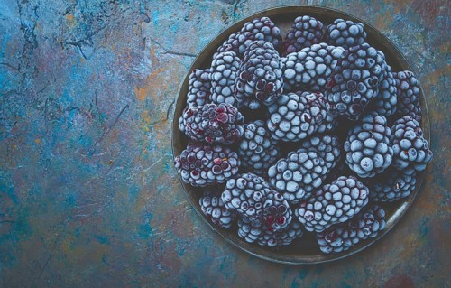 Freshly frozen, blackberries on a plate, top view, no people
