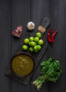 Tkemali sauce, traditional Georgian cuisine, green cherry plum, with ingredients for sauce,