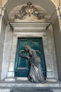 Sculpture of an old woman at a door with an hourglass, Monumental Cemetery, Cimitero monumentale di