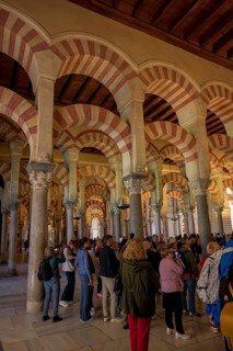 People gather in the cathedral mosque of Cordoba (Mezquita-Catedral), with its magnificent arches