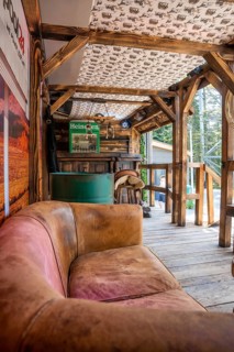 Rustic wood construction with leather sofa and bar