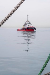 A solitary tugboat navigates the calm waters of the Black Sea near Georgia, surrounded by fog and
