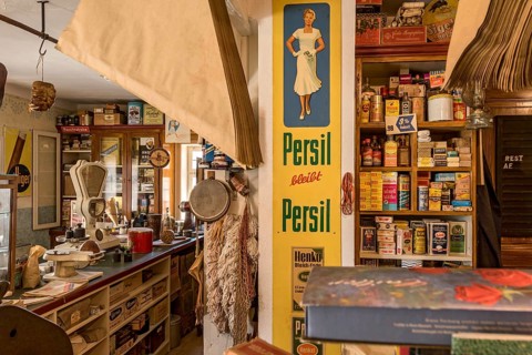 Counter, shelves with goods, tin sign with advertisement for Persil, advertisement, historical
