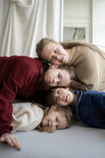 A cozy scene of children and a parent embracing, symbolizing familial love and unity The warm