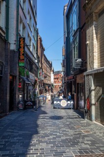 Narrow street in a town with various pubs and shops, Liverpool