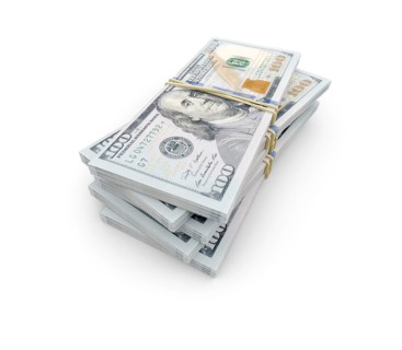 Stacks of thousands of one hundred dollar bills bound by a rubber band isolated on a white