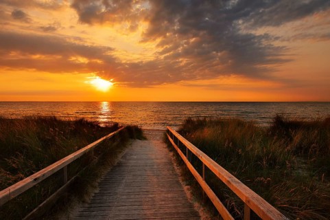 Wooden walkway through the dunes on the Baltic Sea at sunrise, Dahme, Ostholstein, Germany