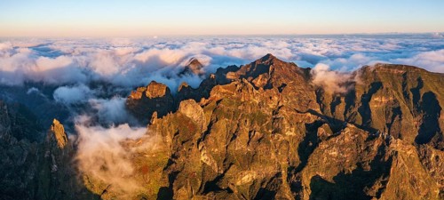 Aerial view, sunrise at Pico do Arieiro, clouds of fog sweeping over mountain peaks, Madeira,