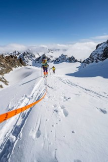 Ski tourer with rope, rope team on the Vadret da Porchabella glacier on the ascent to the summit of
