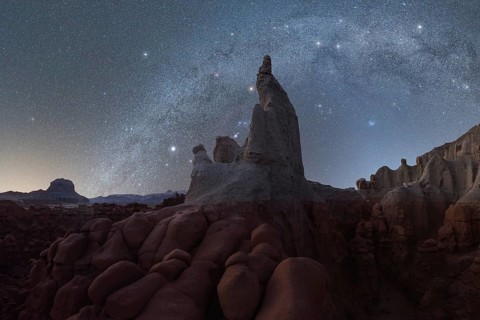 A mesmerizing night sky filled with stars above ancient rock formations in Utah, USA, providing a