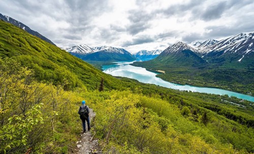 Climbers on a hiking trail, Slaughter Ridge Trail, view of snowy mountains in spring and turquoise