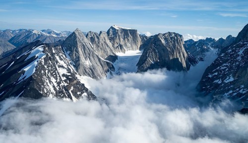 Rock cliffs, snow and ice, epic mountains with glaciers, aerial view, Alaska Range, Denali National