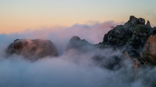 Sunrise at Pico do Arieiro, clouds of fog sweep over mountain peaks, sea of fog, hiking trail PR1,
