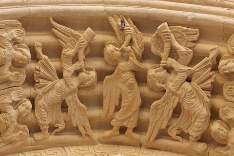 Sculptures with biblical symbolism, angels with trumpets, trombones ringing at the tympanum, stone