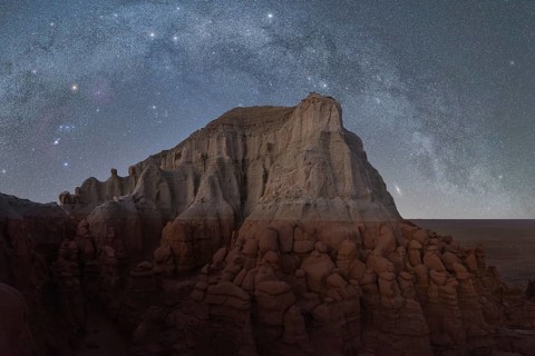 A starry night sky illuminates the unique rock formations in Utah, USA, highlighting a landscape of