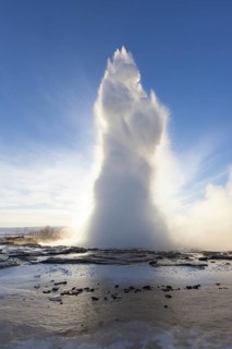 Eruption of Strokkur, fountain geyser in the geothermal area beside the Hvítá River in winter,