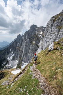 Mountaineer with helmet on a hiking trail, descent from the Maukspitze, rocky mountain peaks with
